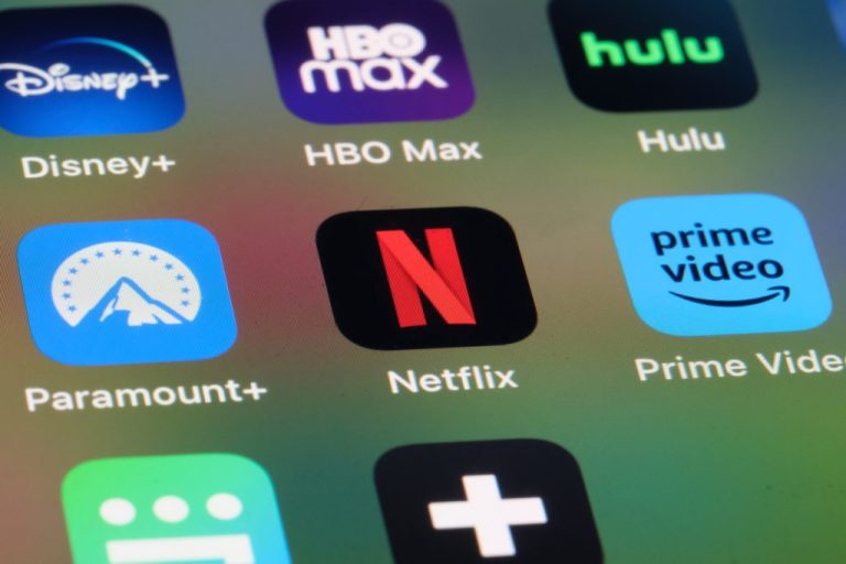 Close-up of a home screen containing Netflix, Amazon Prime Video, Paramount+, Disney+, HBO Max and Hulu app icons via Getty Images. Assorted online subscription video streaming service brands