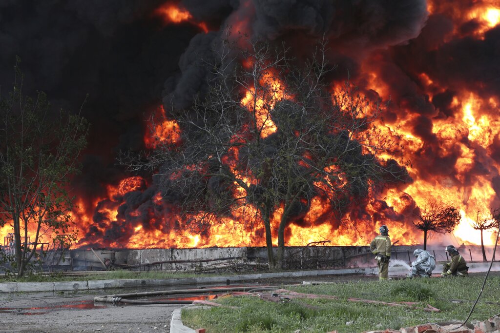 Ukrainian drones set fire to Russian oil depot after Moscow launches new hypersonic missile