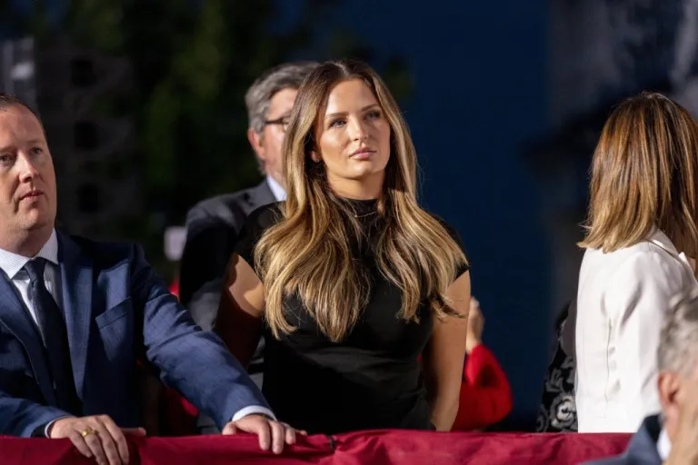 Margo Martin, deputy director of communications for former President Donald Trump, center, watches as he speaks at Trump National Golf Club in Bedminster, N.J., Tuesday, June 13, 2023, after pleading not guilty in a Miami courtroom earlier in the day to dozens of felony counts that he hoarded classified documents and refused government demands to give them back. (AP Photo/Andrew Harnik)