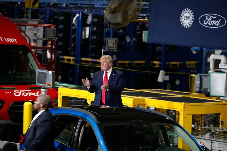 President Donald Trump claps as he walks to the podium to speak at Ford's Rawsonville Components Plant that has been converted to making personal protection and medical equipment, Thursday, May 21, 2020, in Ypsilanti, Mich. Former President Donald Trump will skip the second GOP presidential debate next week to travel to Detroit as the auto worker strike enters its second week. Trump is planning to speak with union members and will look to blunt criticisms from a United Auto Workers union leadership that has said a second Trump term would be a “disaster.” (AP Photo/Alex Brandon, File)