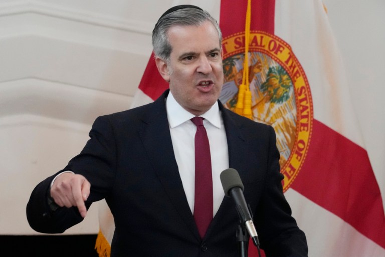 Steven Meiner speaks into microphone in Miami Beach, Florida.