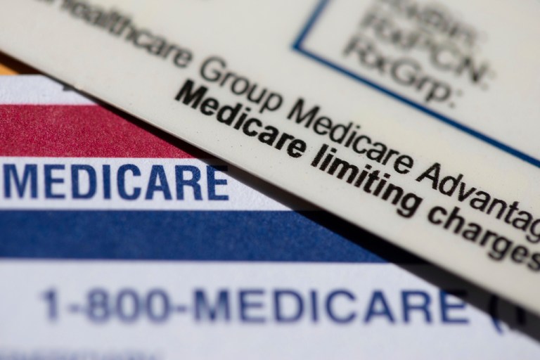 A Medicare Advantage PPO card rests on top of a Medicare card