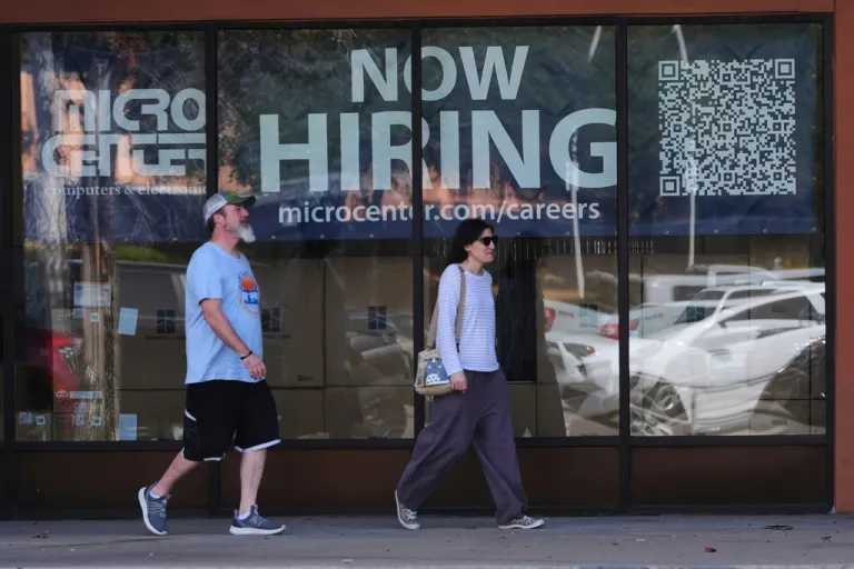 Pedestrians walk by a 