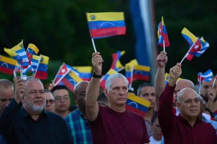 Miguel Diaz-Canel waves a flag at a rally in Havana