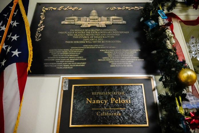A replica plaque commemorating the Jan. 6, 2021 Capitol riot hangs outside the office of Speaker Emerita Nancy Pelosi.