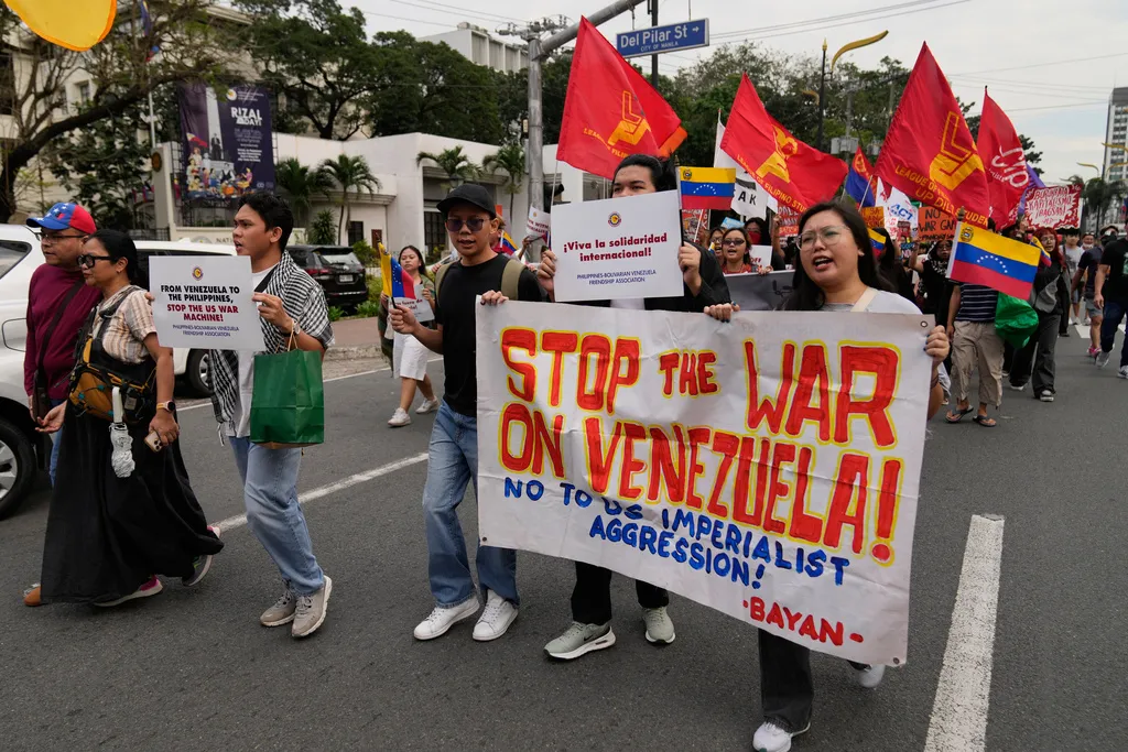 Protesters hold slogans as they denounce the US government and US President Donald Trump after the US captured Venezuelan President Nicolas Maduro during a rally near the US embassy in Manila, Philippines on Monday, Jan. 5, 2026. (AP Photo/Aaron Favila)