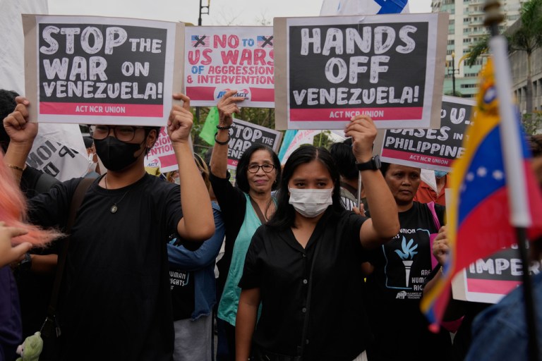 Protesters hold slogans as they denounce the U.S. government and President Donald Trump after the U.S. captured former Venezuelan dictator Nicolas Maduro during a rally near the U.S. Embassy in Manila, Philippines.