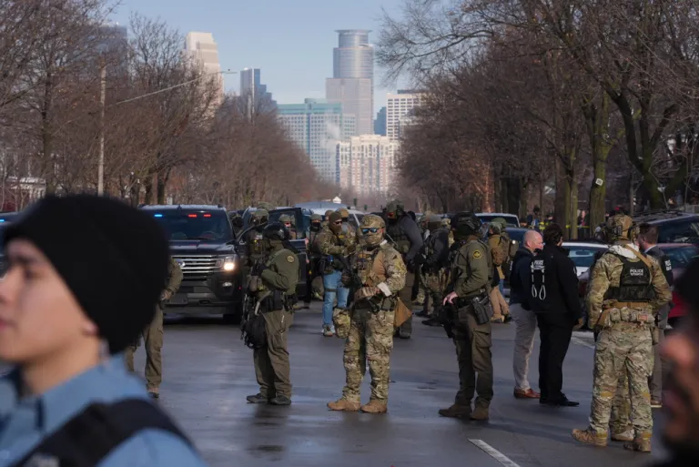 Law enforcement agents stand on the scene of a shooting in Minneapolis.