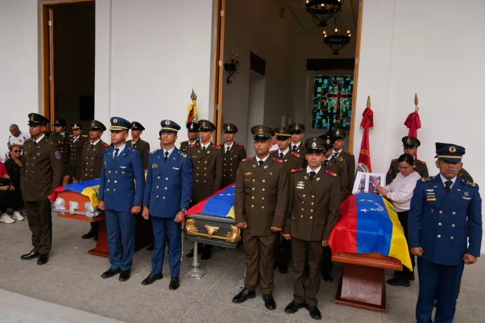 Venezuelan soldiers stand beside the caskets of fellow military personnel killed in the Maduro abduction