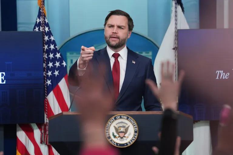 Vice President JD Vance points to reporters with their hands raised during a press conference in the James S. Brady Press Briefing Room at the White House.