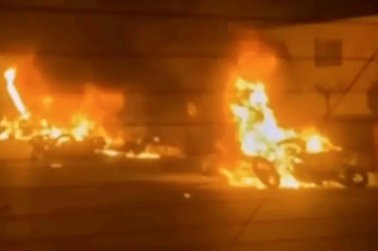 Vehicles burn in the streets of Tehran, Iran.
