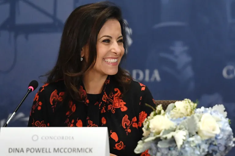 Dina Powell McCormick sits at a panel.