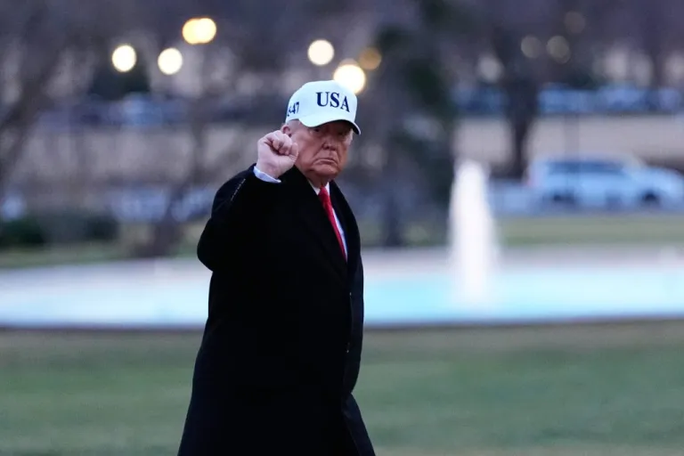 President Donald Trump gestures as he walks from Marine One after arriving on the South Lawn of the White House, Tuesday, Jan. 13, 2026, in Washington.