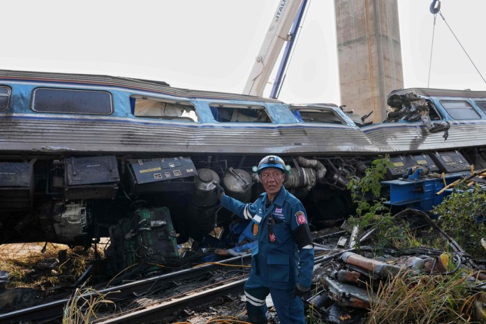 A construction crane falls onto a moving train in Thailand, killing at least 32 people