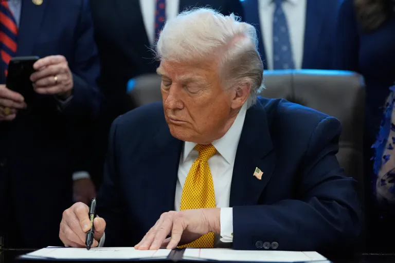 President Donald Trump signs a bill to return whole milk to school cafeterias nationwide in the Oval Office of the White House.