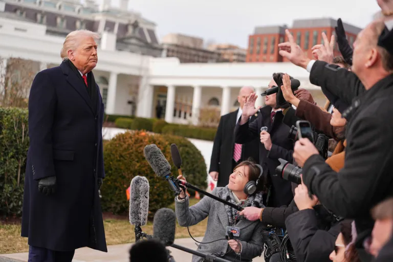 President Donald Trump takes questions from reporters before departing on Marine One from the South Lawn of the White House.