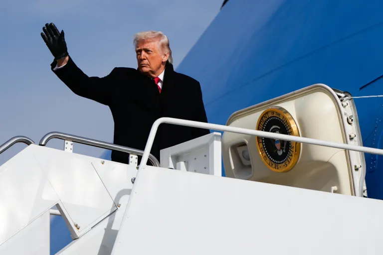 Trump waves as he boards Air Force One.