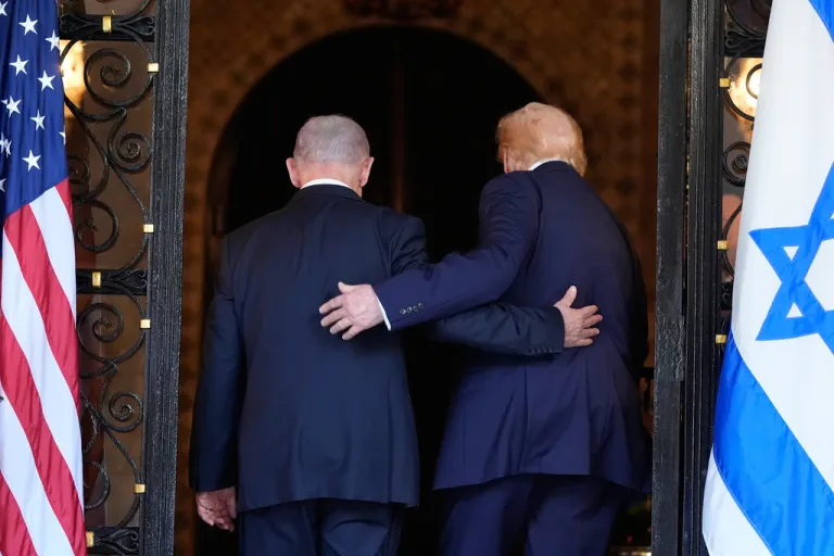 President Donald Trump and Israel's Prime Minister Benjamin Netanyahu walk arm in arm into Trump's Mar-a-Lago club in Palm Beach, Fla., Dec. 29, 2025.