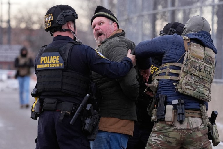 Law enforcement detain a man outside the Bishop Henry Whipple Federal Building during a protest on Saturday, Jan. 17, 2026, in Minneapolis.
