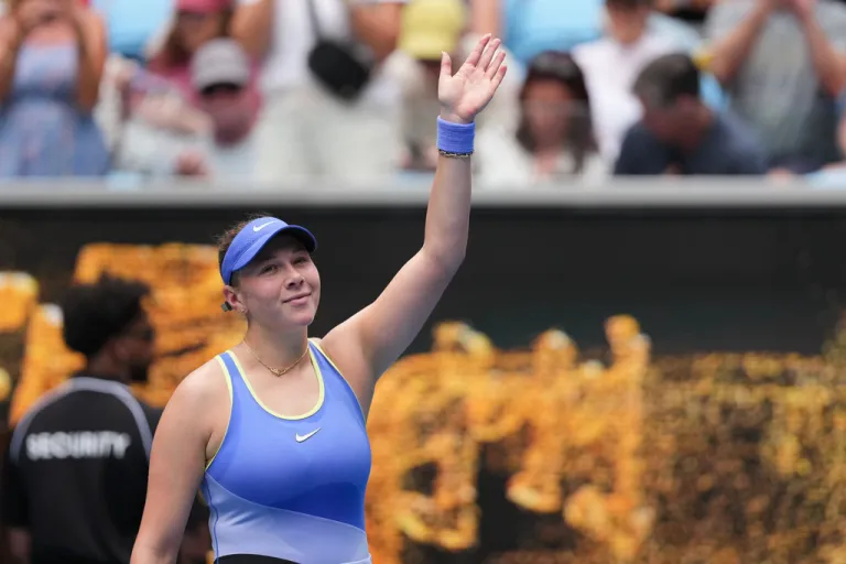 Amanda Anisimova waves after defeating Simona Waltert in their first round match at the Australian Open tennis championship in Melbourne, Australia.