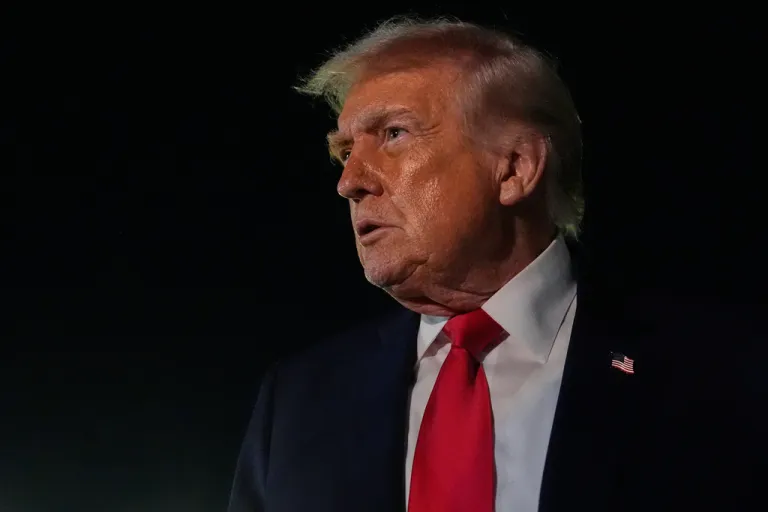 President Donald Trump speaks to reporters before boarding Air Force One at Palm Beach International Airport.