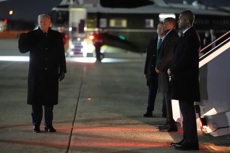President Donald Trump gestures before boarding Air Force One for a trip to attend the World Economic Form in Davos, Tuesday, Jan. 20, 2026, at Joint Base Andrews, Md.