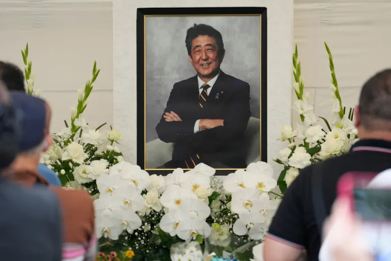 People offer prayers for former Prime Minister Shinzo Abe at Zojoji temple in Tokyo.