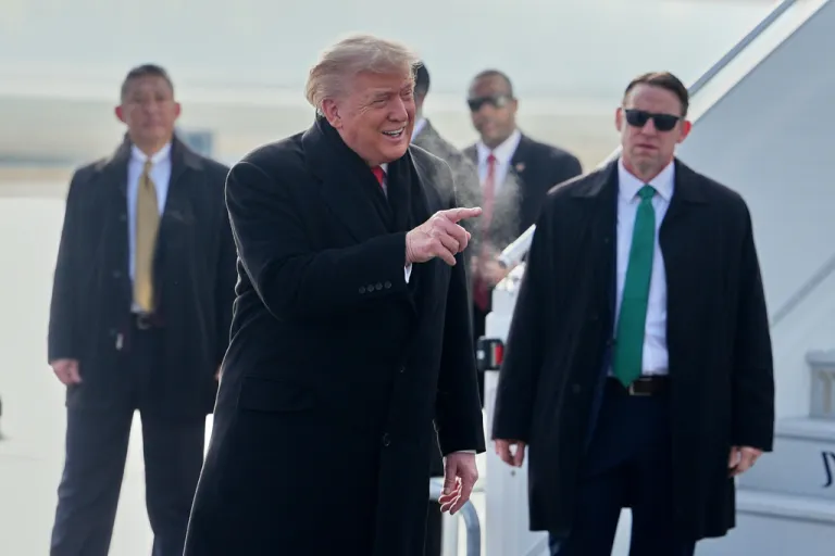 President Donald Trump, center, points his finger as he steps off Air Force One after arriving at Zurich International Airport for the World Economic Forum, Wednesday, Jan. 21, 2026, in Zurich, Switzerland.