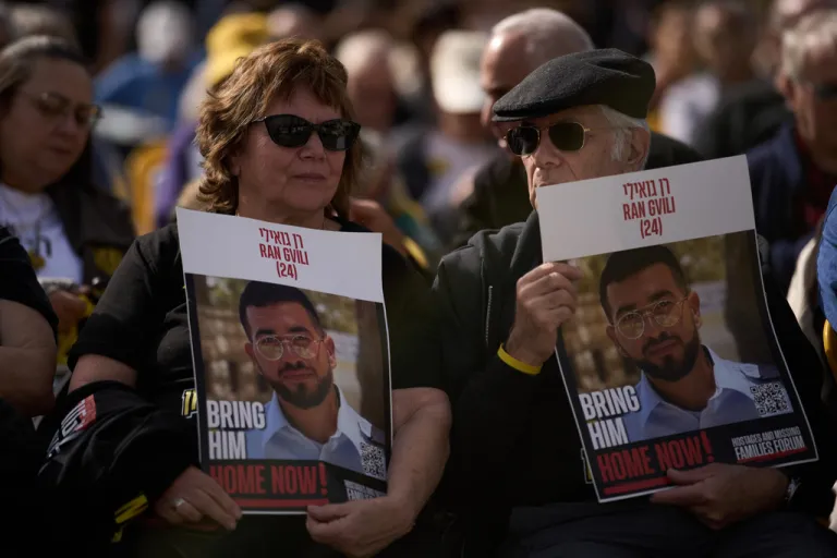 People hold signs with a photo of Ran Gvili, who was killed while fighting Hamas militants during the Oct. 7, 2023, terrorist attack and whose body has been held in Gaza ever since, during a rally calling for his return in Tel Aviv.