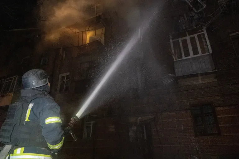Emergency services personnel work to extinguish a fire following a Russian attack in Kharkiv, Ukraine, Saturday, Jan. 24, 2026.