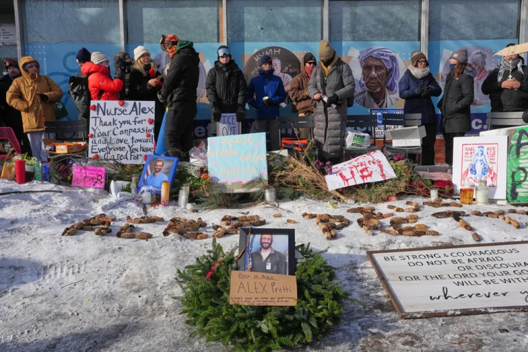 People gather near the scene where Alex Pretti was fatally shot by a Border Patrol agent yesterday in Minneapolis.