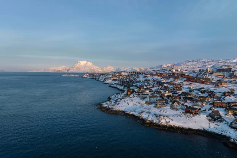 Houses are seen near the coast of a sea inlet of Nuuk, Greenland.
