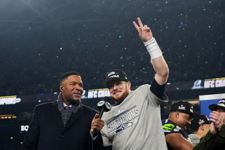Seattle Seahawks quarterback Sam Darnold celebrates next to Michael Strahan after a win over the Los Angeles Rams in the NFC Championship NFL football game.
