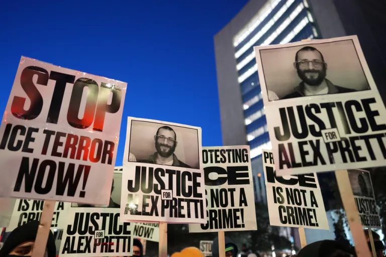 Demonstrators hold signs during a rally against federal immigration enforcement at Federal Courthouse Plaza on Tuesday, Jan. 27, 2026, in Minneapolis. (AP Photo/Adam Gray)