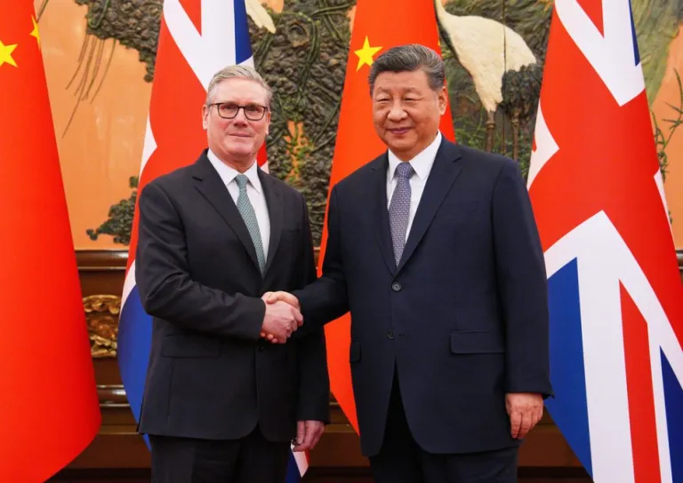 U.K. Prime Minister Keir Starmer shakes hands with Chinese President Xi Jinping.