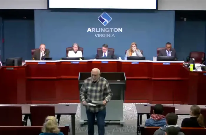 man walking away from podium at Arlington County Board meeting