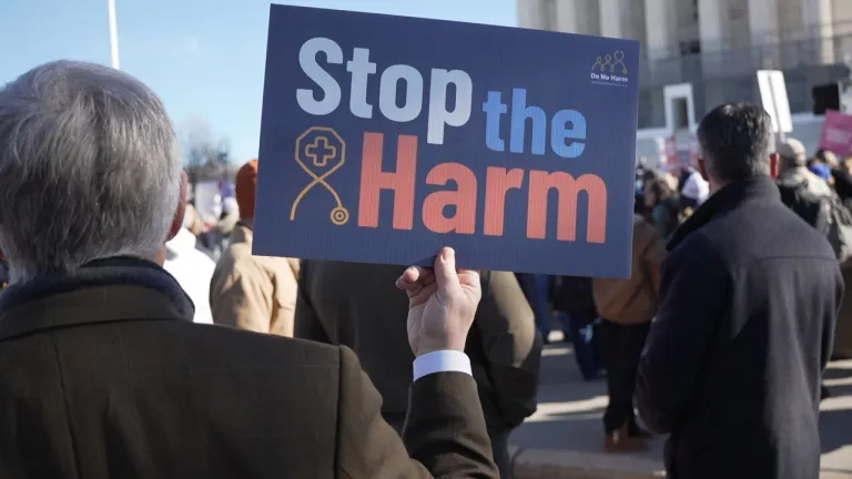 Protesters hold signs outside the Supreme Court before the Little v. Hecox and West Virginia v. B.P.J. cases are heard.