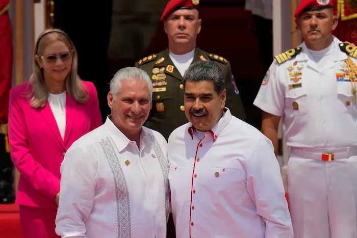Venezuelan President Nicolas Maduro, right, poses for photos with Cuba's President Miguel Diaz-Canel before the start of a summit by the Bolivarian Alliance for the Peoples of Our America (ALBA) at Miraflores presidential palace in Caracas, Venezuela, Wednesday, April 24, 2024. (AP Photo/Ariana Cubillos)