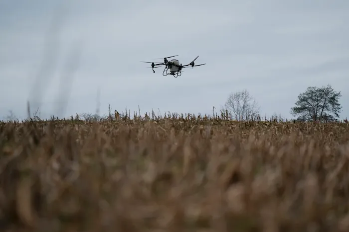 A DJI drone puts crop cover on a farm.