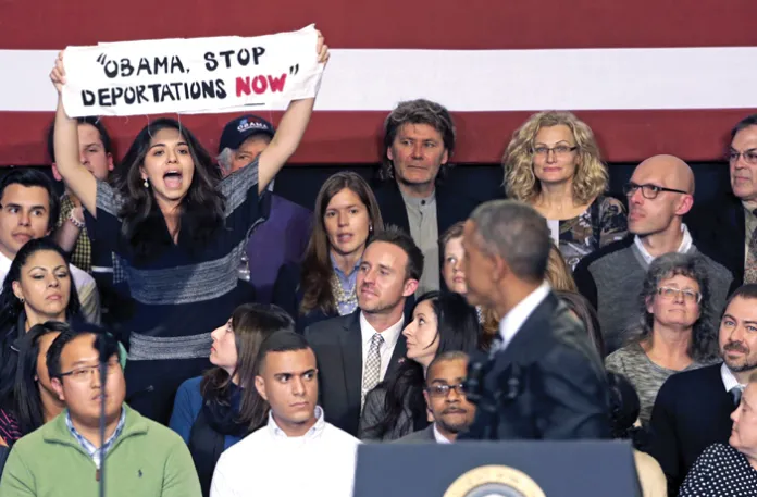 A woman interrupts President Barack Obama during his address to community leaders about executive actions aimed at reforming the immigration system, Nov. 25, 2014. (Charles Rex Arbogast/AP)