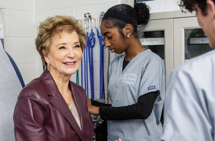 Education Secretary Linda McMahon gets her finger pricked by a student at St. Georges Technical High School in Delaware. (Courtesy of Linda Mcmahon staff)