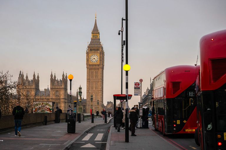 Commuters in Westminster with the Elizabeth Tower, also known as Big Ben, and Houses of Parliament in the background in London, UK, on Wednesday, Dec. 17, 2025. The UK's Labour government passed a workers' rights package that expands protections for employees and achieves a key policy goal of the party's left. Photographer: Jose Sarmento Matos/Bloomberg via Getty Images