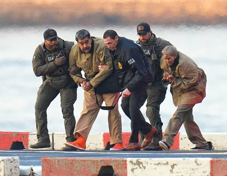 Nicolas Maduro and his wife, Cilia Flores, are seen in handcuffs after landing at a Manhattan helipad, escorted by heavily armed Federal agents, as they make their way into an armored car en route to a Federal courthouse in Manhattan.