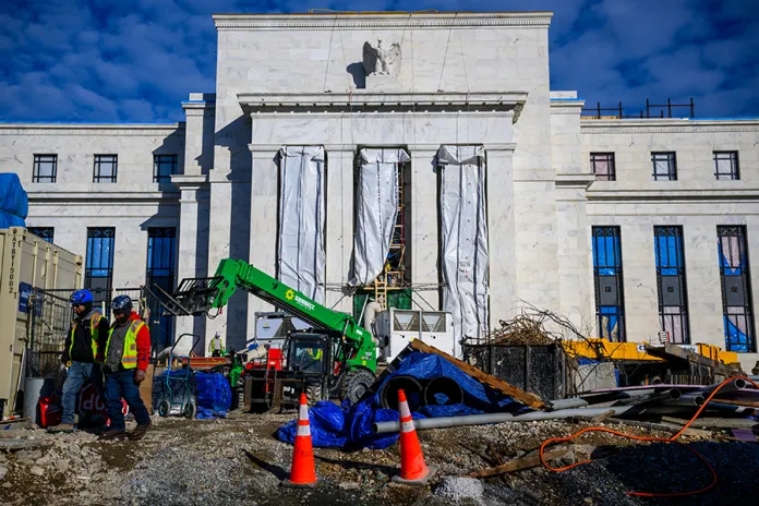 Construction workers outside the Marriner S. Eccles Federal Reserve building in Washington, DC, US, on Monday, Jan. 12, 2026. Federal Reserve Chair Jerome Powell said the US central bank had been served grand jury subpoenas from the Justice Department threatening a criminal indictment, a dramatic escalation of the Trump administration's attacks on the institution. Photographer: Pete Kiehart/Bloomberg via Getty Images