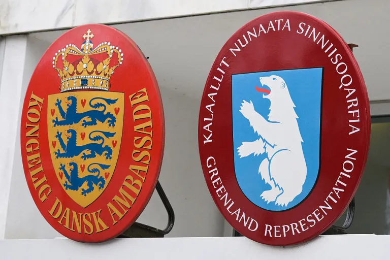 The Danish coat of arms and Greenland's coat of arms are seen at the Danish Embassy in Washington, DC, ahead of a news conference with Danish Foreign Minister Lars Lokke Rasmussen and Greenland's Foreign Minister Vivian Motzfeldt on January 14, 2026. Denmark and Greenland's top diplomats held high-stakes talks at the White House on Wednesday, with President Donald Trump warning it was 