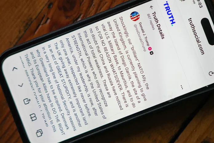 A phone shows a post on Truth Social by President Donald Trump critisizing the UK's handover of the Chagos Islands on January 20, 2026. (Christopher Furlong/Getty Images)