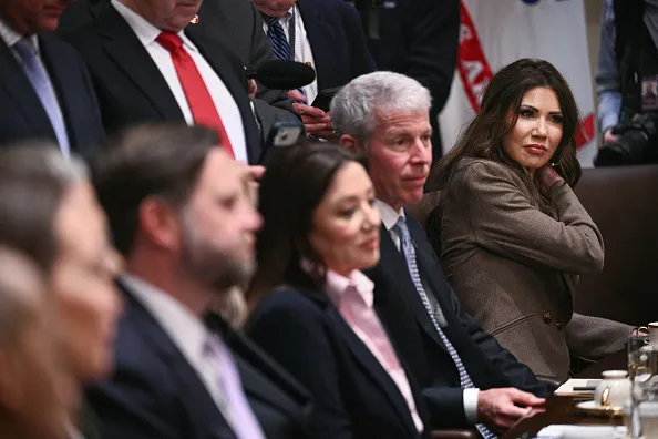 US Secretary of Homeland Security Kristi Noem (R) looks on as President Donald Trump hosts a cabinet meeting in the Cabinet Room of the White House in Washington, DC, on January 29, 2026. (Photo by Brendan SMIALOWSKI / AFP via Getty Images)