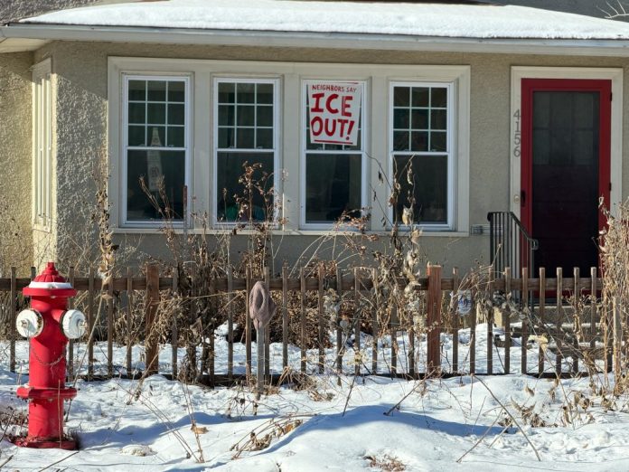 A sign that states "ICE OUT!" hangs in a front window of a house in Southeast Minneapolis where both Renee Nicole Good and Alex Pretti were killed by federal police in January 2026. (Anna Giaritelli / Washington Examiner)