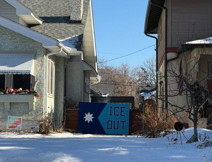 A painting that states "ICE OUT" stands in between houses in Southeast Minneapolis where both Renee Nicole Good and Alex Pretti were killed by federal police in January 2026. (Anna Giaritelli / Washington Examiner)