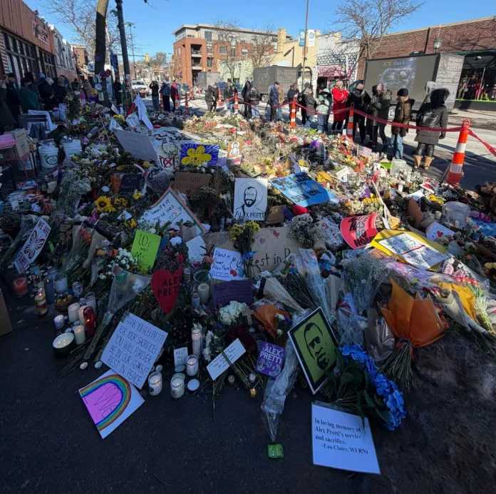 Community members look at a tribute to Alex Pretti, a Minneapolis nurse who was killed in a shooting by federal law enforcement on Jan. 24, 2026. (Anna Giaritelli/Washington Examiner)